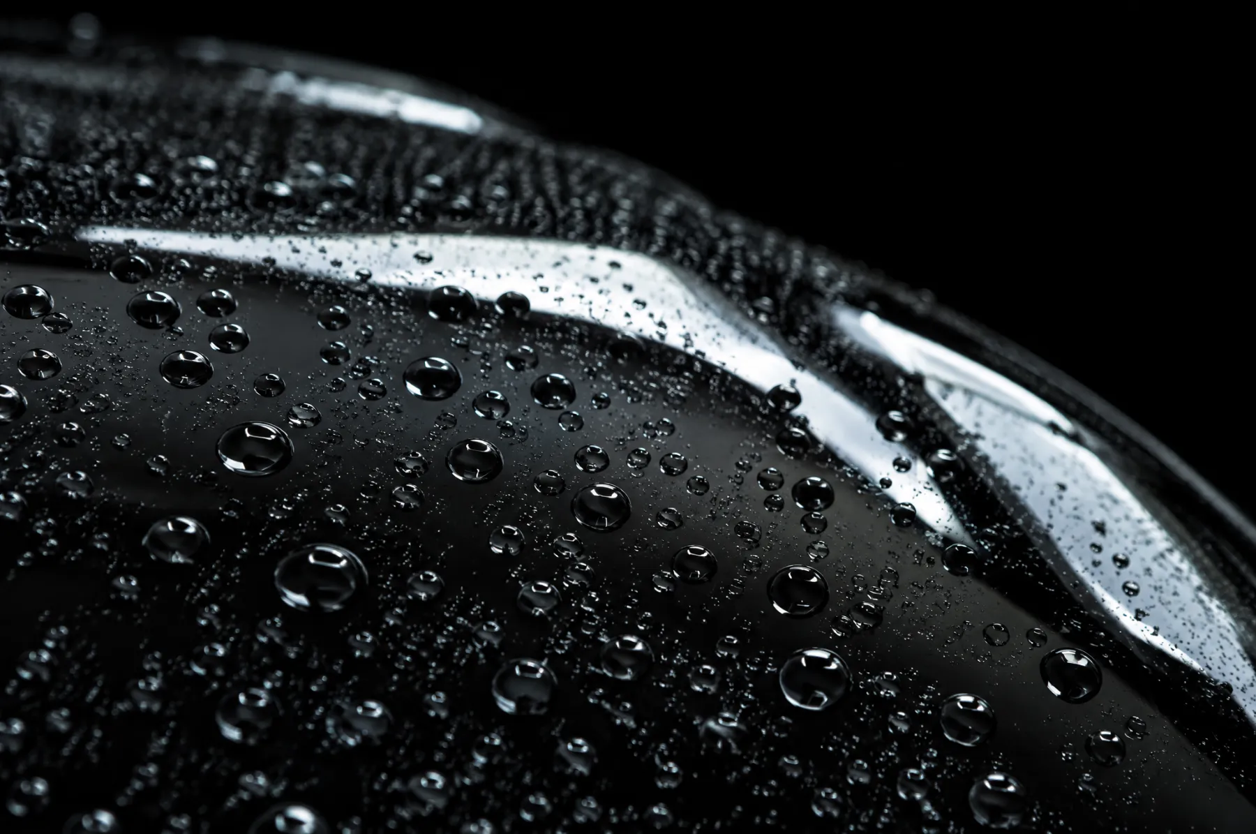 Water beading on waxed black paint